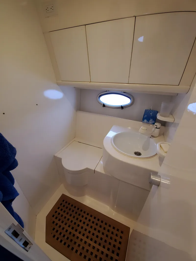 Slide: The Image of Compact bathroom in a 1993 Giorgi 46 yacht with sink, storage, and porthole. - 20