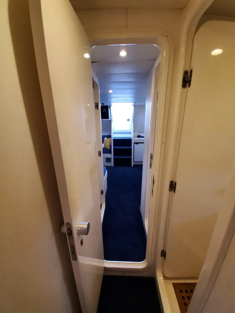 Slide: The Image of Interior view of 1993 Giorgi 46 yacht, showing hallway and cabin entrance. - 25