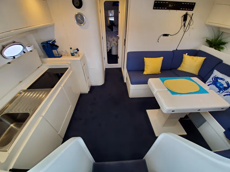 Slide: The Image of Luxurious Giorgi 46 yacht interior, featuring a cozy dining area and modern kitchen, 1993 model. - 26