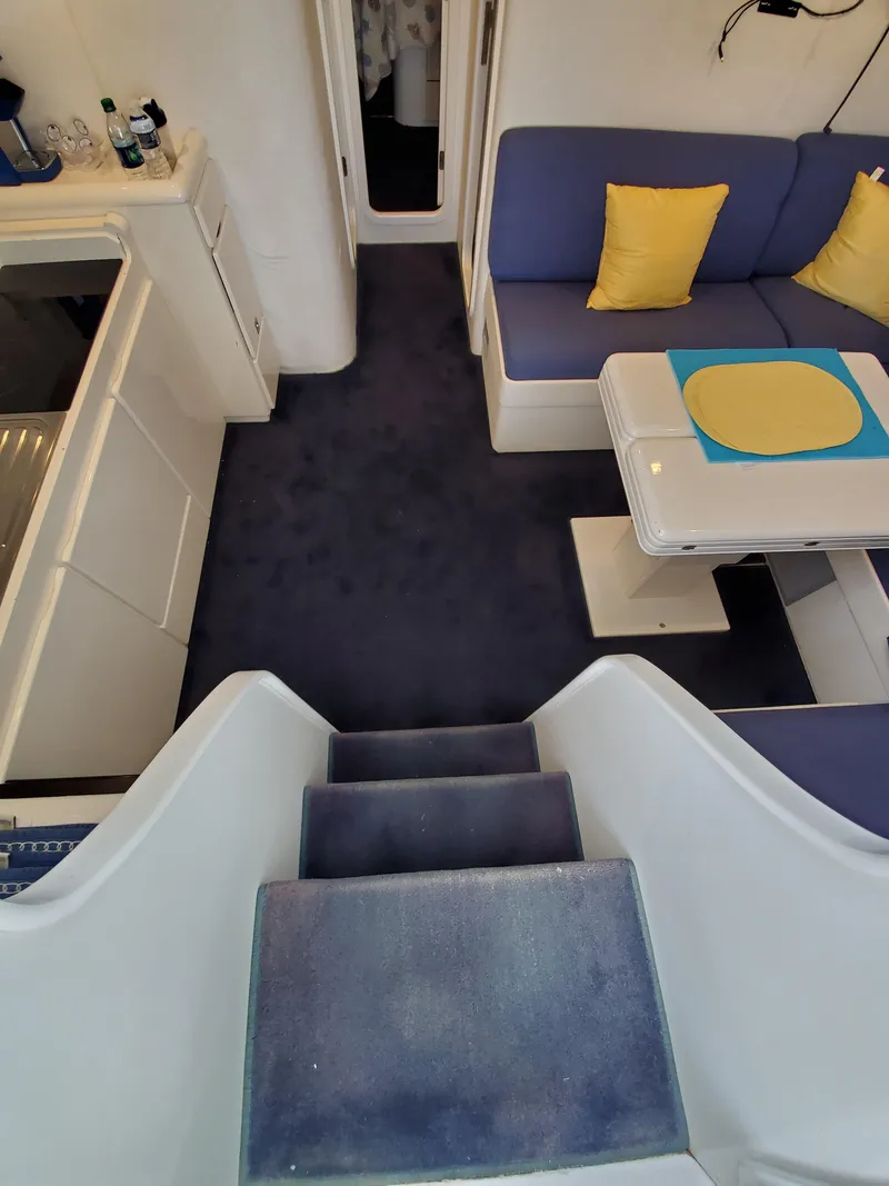 Slide: The Image of Interior of a 1993 Giorgi 46 yacht with blue carpet and seating. - 27