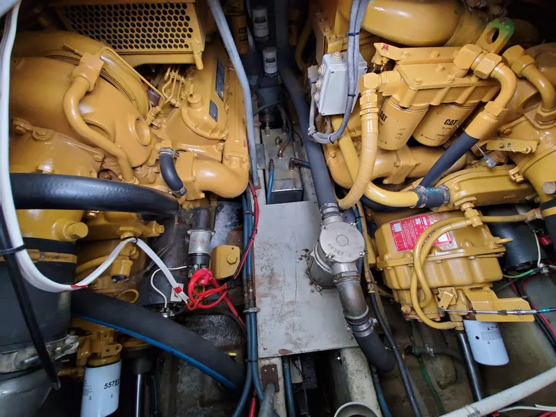 Slide: The Image of Engine room of a 1993 Giorgi 46 boat, featuring yellow machinery and various pipes. - 37