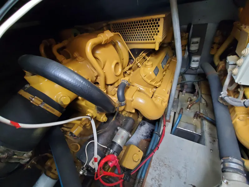 Slide: The Image of Engine compartment of a 1993 Giorgi 46 boat, featuring yellow machinery and various hoses. - 39
