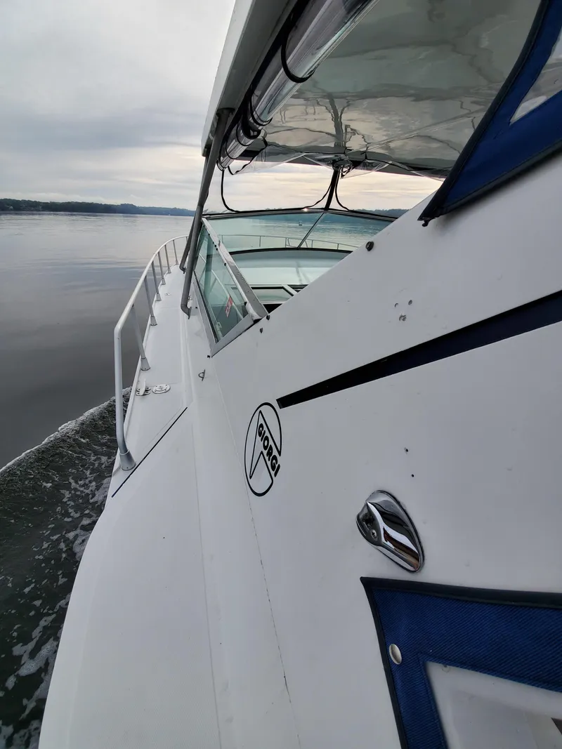 Slide: The Image of Giorgi 46 boat cruising on calm waters, side view, overcast sky, 1993 model. - 47