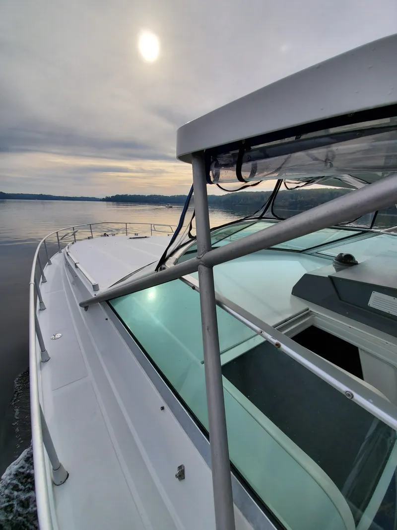 Slide: The Image of 1993 Giorgi 46 yacht cruising on calm waters under a cloudy sky. - 49