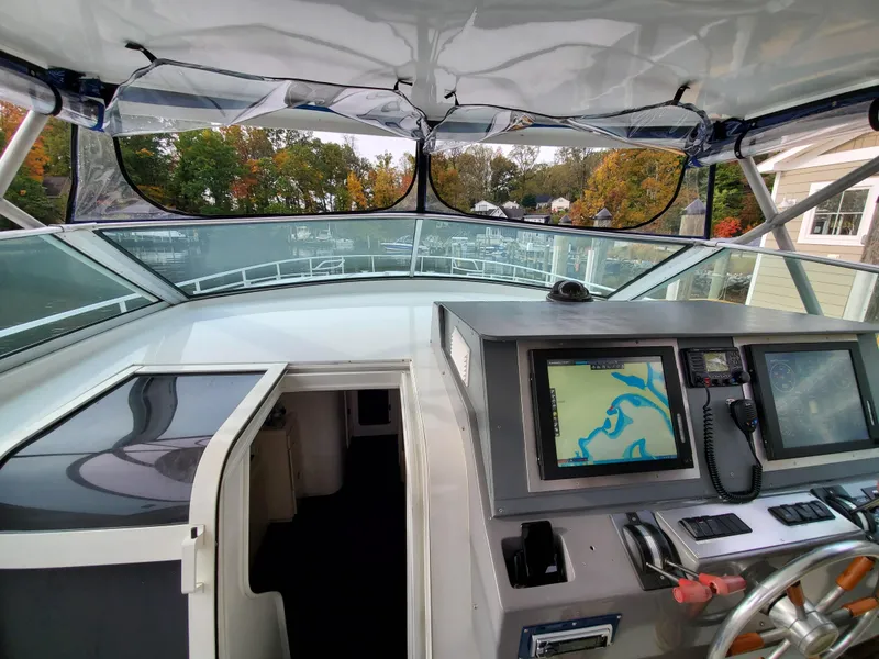 Slide: The Image of Cockpit view of a 1993 Giorgi 46 boat with navigation equipment and scenic background. - 9