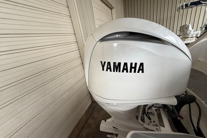 Slide: The Image of Yamaha outboard motor on a 2026 Regal 26 XO boat in a storage facility. - 10