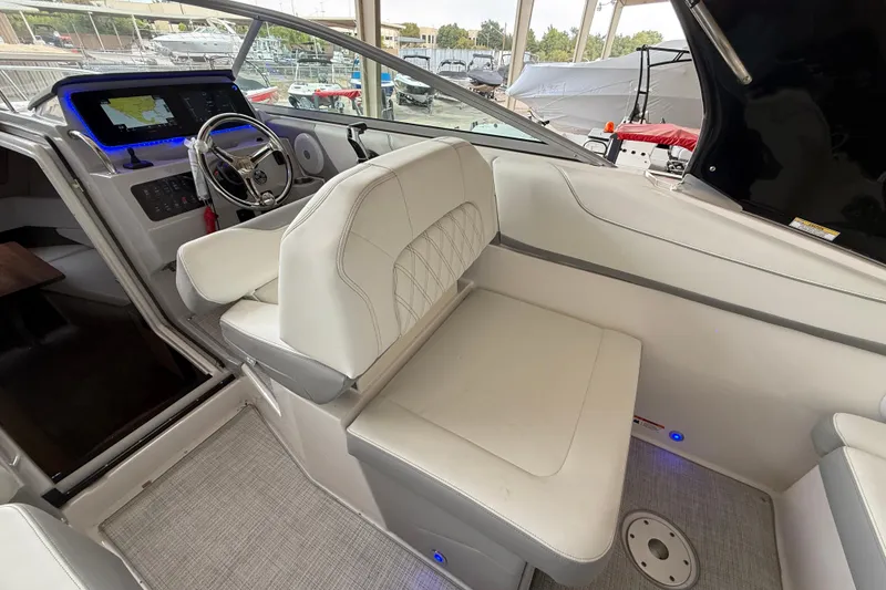 Slide: The Image of 2026 Regal 26 XO boat interior with modern dashboard and white seating. - 16