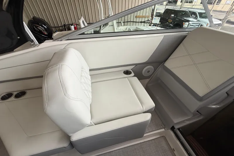 Slide: The Image of 2026 Regal 26 XO boat interior with white seating and cup holders. - 17