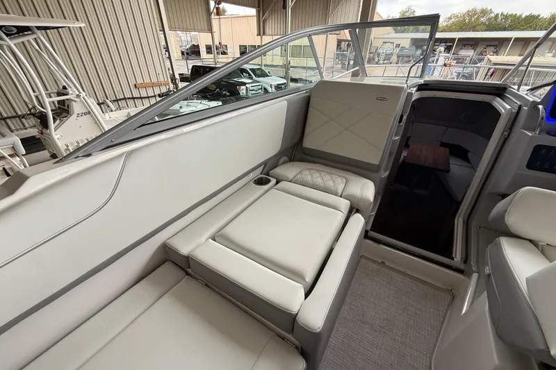 Slide: The Image of 2026 Regal 26 XO boat interior with plush seating and cabin entrance. - 18