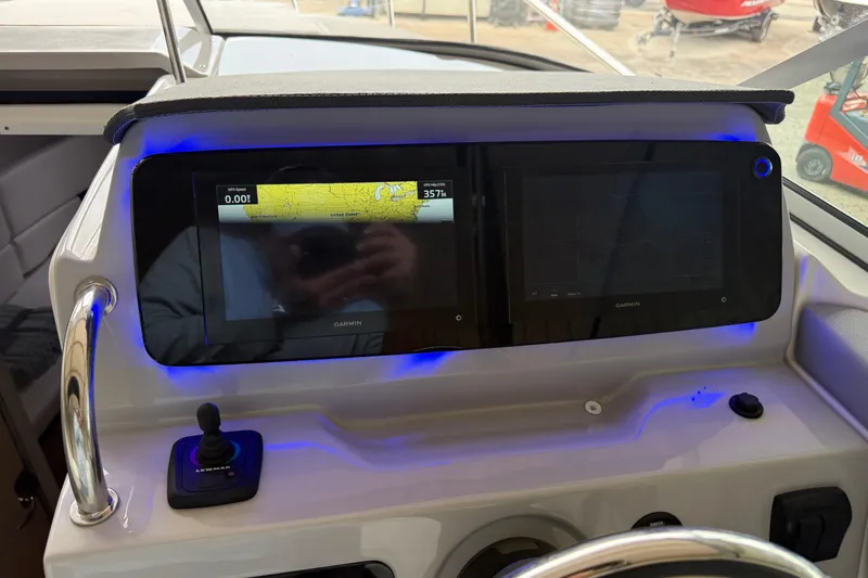 Slide: The Image of 2026 Regal 26 XO boat dashboard with dual Garmin displays and navigation controls. - 21