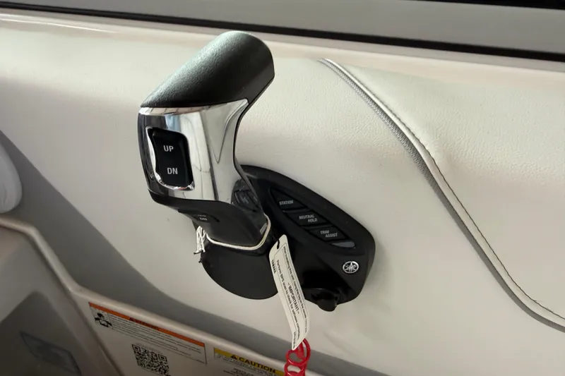 Slide: The Image of Throttle control of 2026 Regal 26 XO boat with UP/DN buttons and key. - 25