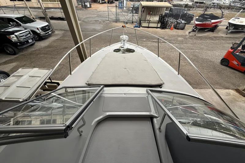 Slide: The Image of 2026 Regal 26 XO boat deck view in storage facility with surrounding vehicles. - 31