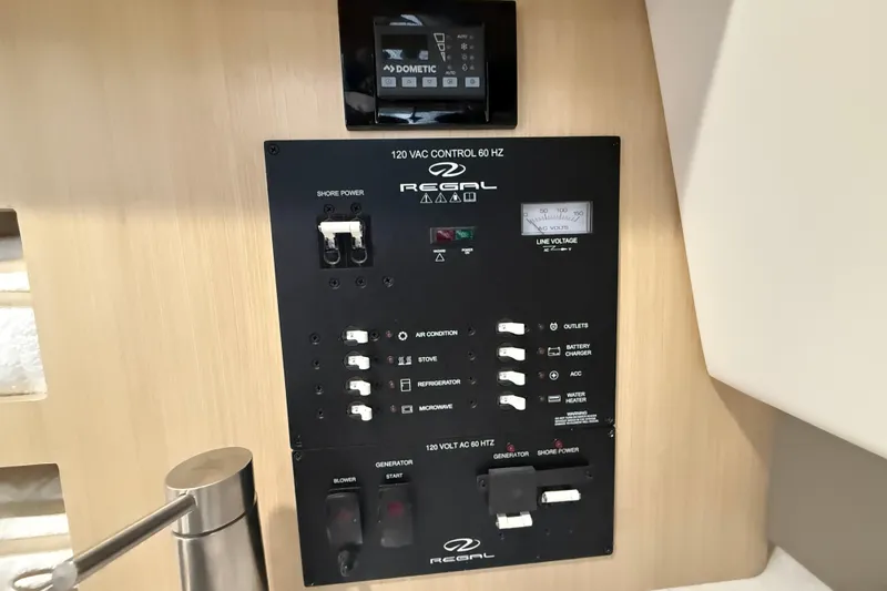 Slide: The Image of Control panel of 2026 Regal 26 XO boat with various switches and voltage display. - 40