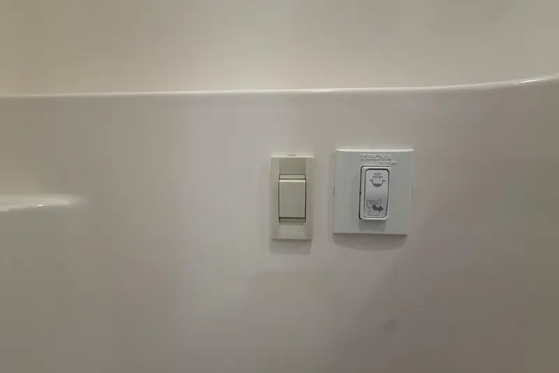 Slide: The Image of Light and control switches on a Regal 26 XO, 2026 model boat interior. - 43