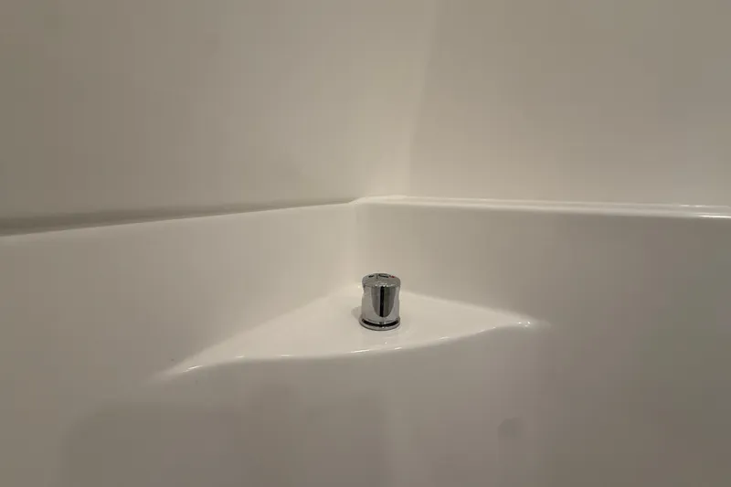 Slide: The Image of White corner shelf with chrome fixture in a modern setting, Regal 26 XO 2026. - 44