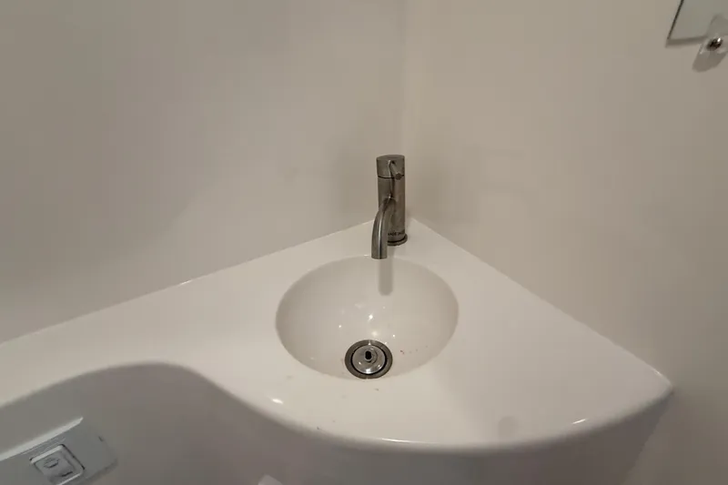 Slide: The Image of Corner sink with modern faucet in a compact bathroom on Regal 26 XO, 2026 model. - 45