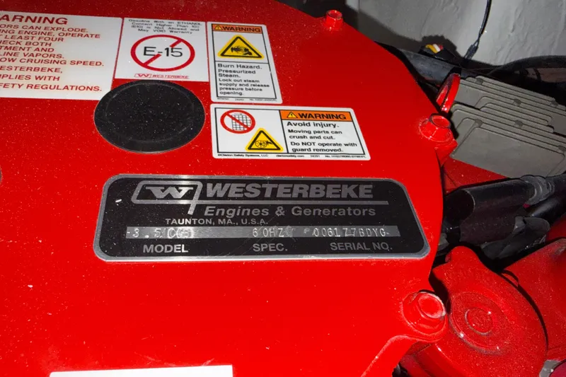 Slide: The Image of Red Westerbeke engine with warning labels on a 2026 Regal 26 XO boat. - 49