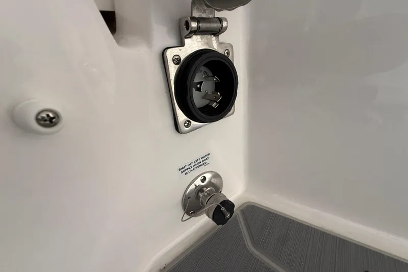 Slide: The Image of 2026 Regal 26 XO boat water and power connection ports. - 51