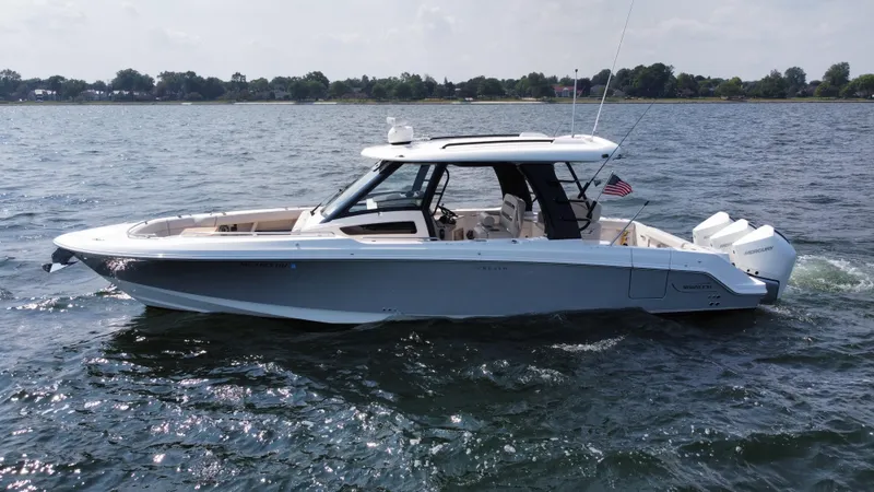 The Image of 2022 Boston Whaler 350 Realm boat cruising on a calm lake. - 0