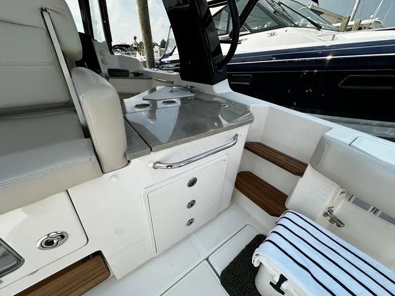 Slide: The Image of 2022 Boston Whaler 350 Realm interior with seating, storage, and sleek design. - 15