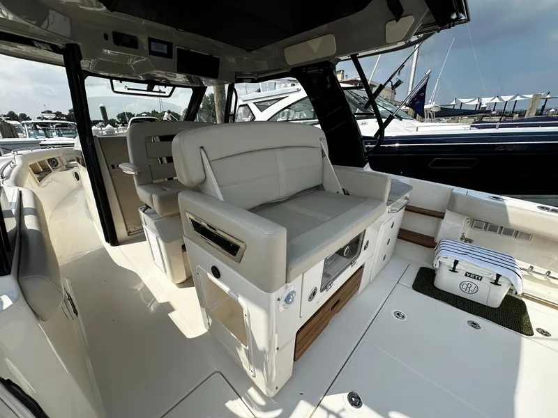 Slide: The Image of 2022 Boston Whaler 350 Realm interior with luxurious seating and modern design. - 17
