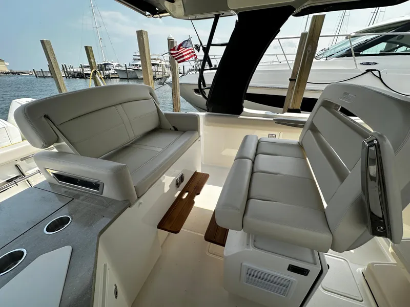 Slide: The Image of Boston Whaler 350 Realm 2022 boat interior with seating and dock view. - 20