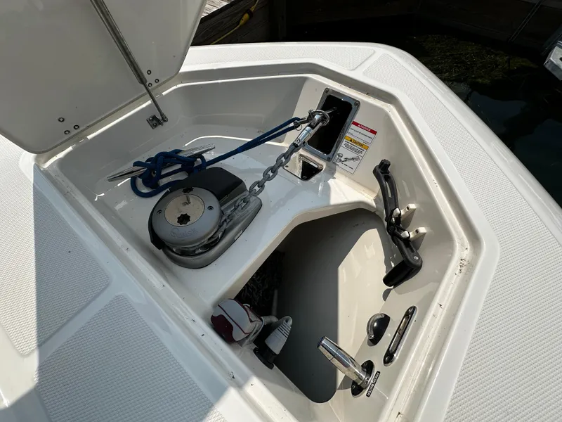 Slide: The Image of 2022 Boston Whaler 350 Realm anchor compartment with chain and rope storage. - 29