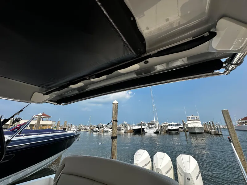 Slide: The Image of Boston Whaler 350 Realm 2022 at marina with multiple boats and clear sky. - 32