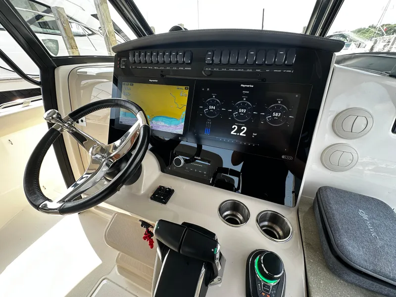 Slide: The Image of 2022 Boston Whaler 350 Realm dashboard with navigation and control systems. - 33