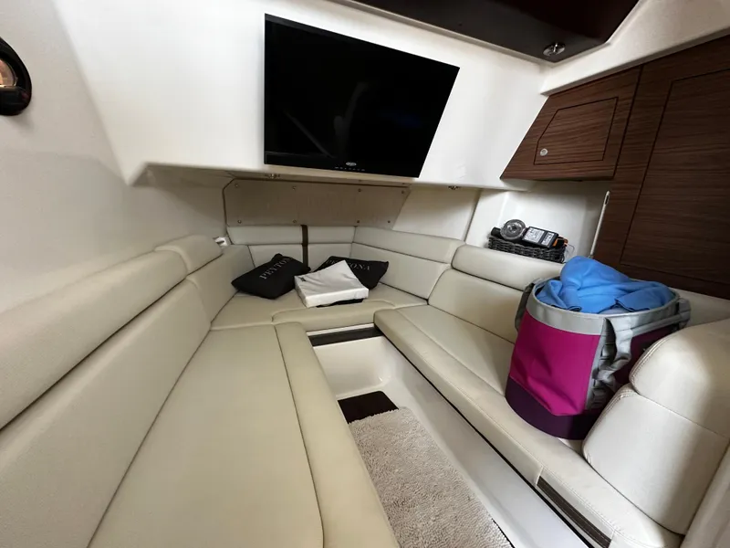 Slide: The Image of Interior of 2022 Boston Whaler 350 Realm, featuring plush seating and a mounted TV. - 39