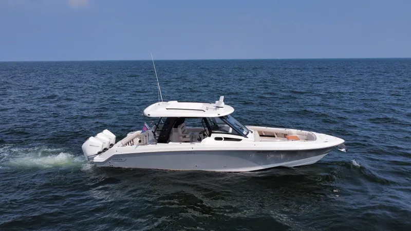 Slide: The Image of 2022 Boston Whaler 350 Realm cruising on open water under clear skies. - 4