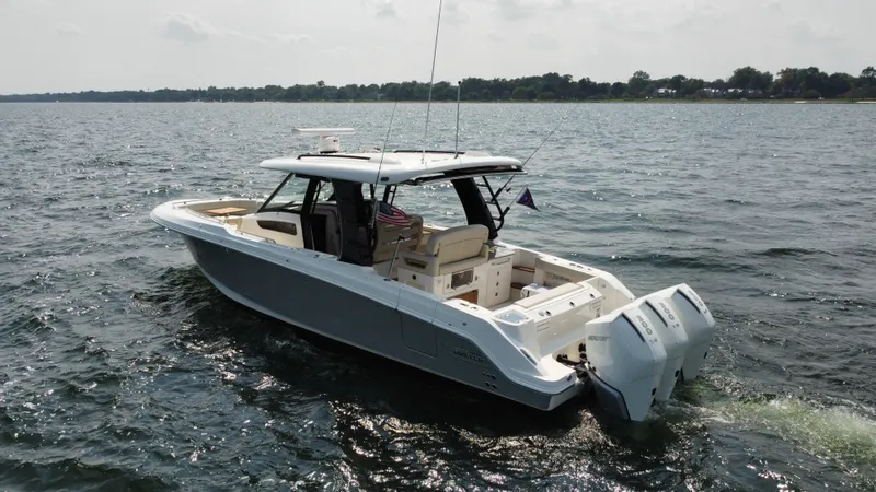 Slide: The Image of 2022 Boston Whaler 350 Realm boat cruising on a calm lake. - 7