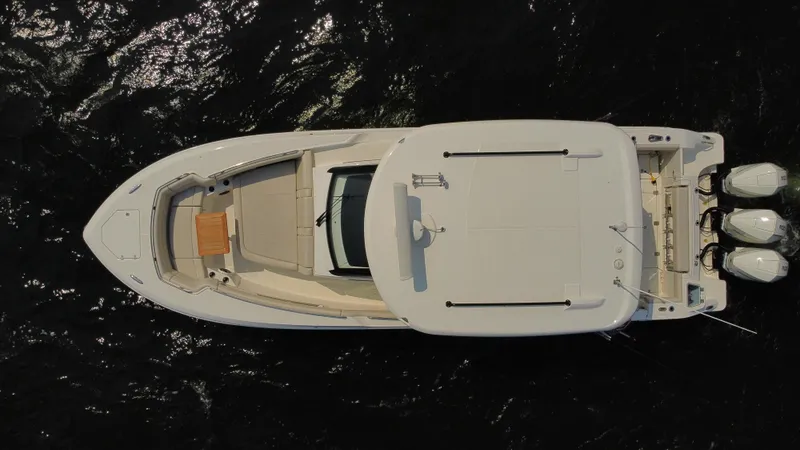 Slide: The Image of Aerial view of 2022 Boston Whaler 350 Realm boat on dark water. - 8