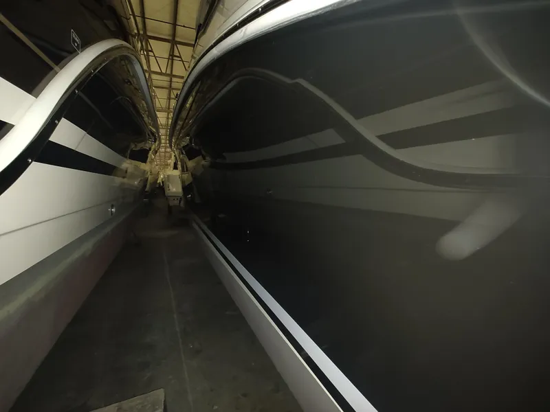 Slide: The Image of 2023 Sea Ray 320 Sundancer boats in storage facility. - 10