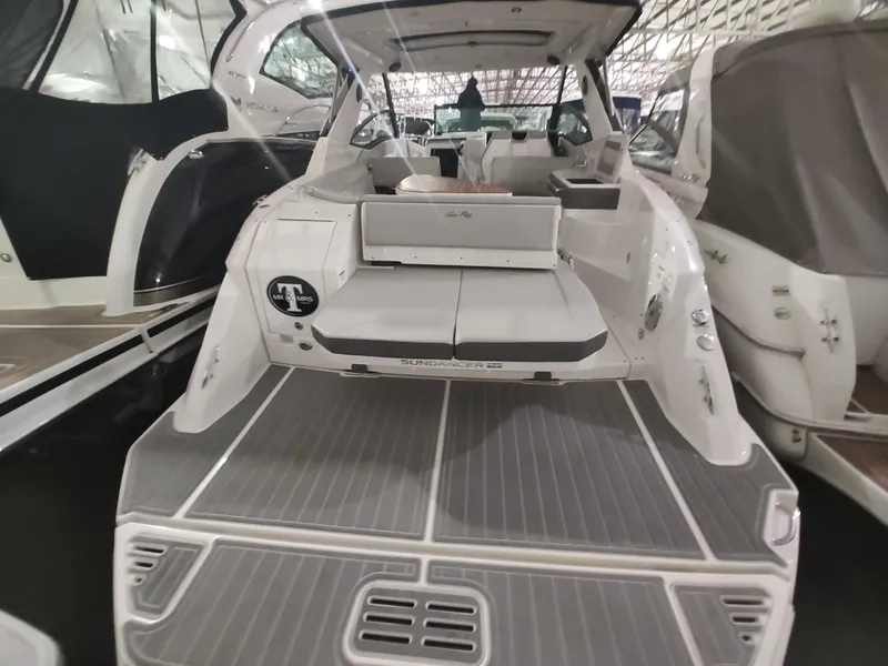 Slide: The Image of 2023 Sea Ray 320 Sundancer yacht, rear view, docked in a marina. - 17