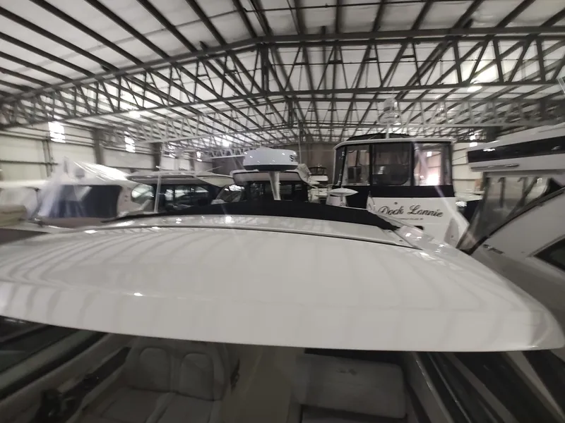 Slide: The Image of 2023 Sea Ray 320 Sundancer in a boat storage facility. - 22