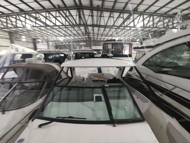 Slide: The Image of 2023 Sea Ray 320 Sundancer in a boat showroom. - 28