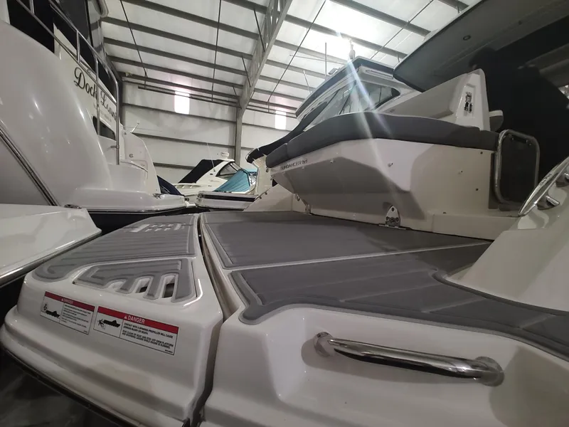 Slide: The Image of 2023 Sea Ray 320 Sundancer in a boat showroom. - 30
