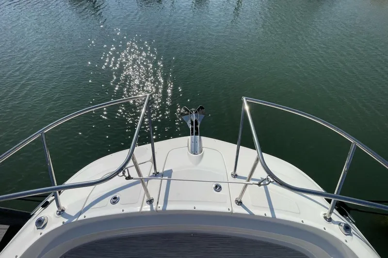 Slide: The Image of Bow view of 2023 Sea Ray 320 Sundancer, sparkling water reflections. - 5