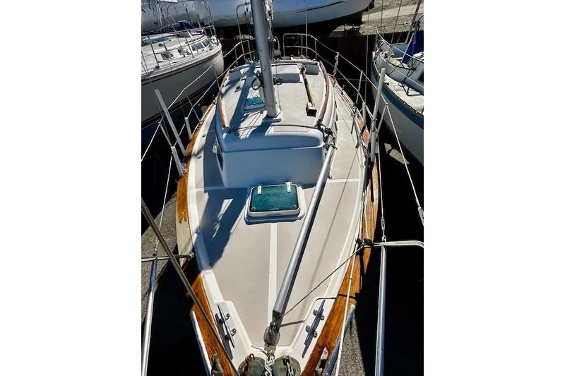 Slide: The Image of 1987 Island Packet 27 sailboat deck view with wooden trim and rigging. - 18