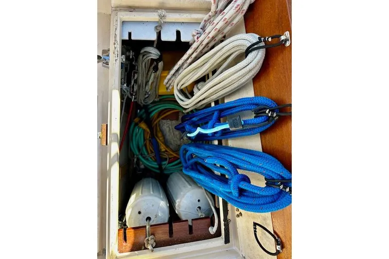 Slide: The Image of Storage compartment on 1987 Island Packet 27 sailboat with ropes and fenders. - 20