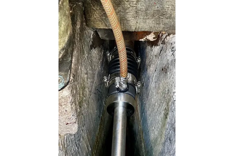 Slide: The Image of Close-up of a 1987 Island Packet 27 boat's shaft seal and hose connection. - 23