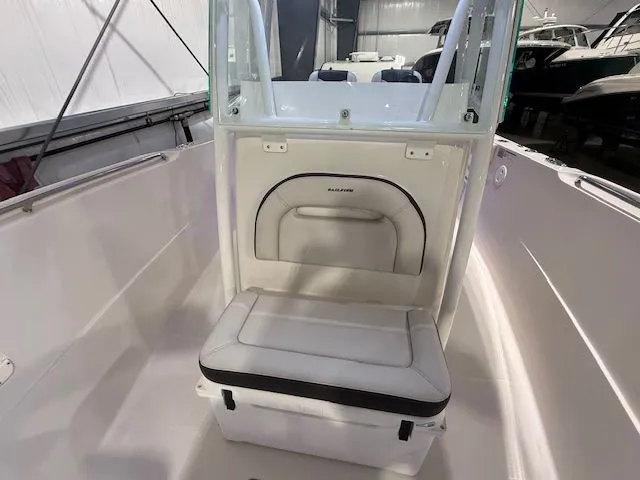 Slide: The Image of 2022 Sailfish 290cc boat interior with cushioned seating and storage compartment. - 14