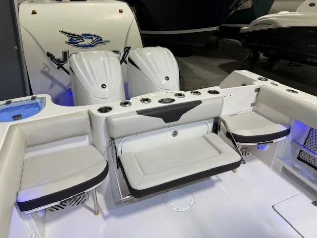 Slide: The Image of 2022 Sailfish 290cc boat interior with seating and dual outboard motors. - 15