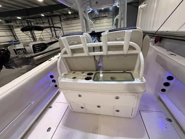 Slide: The Image of 2022 Sailfish 290cc boat interior with seating and storage compartments. - 16