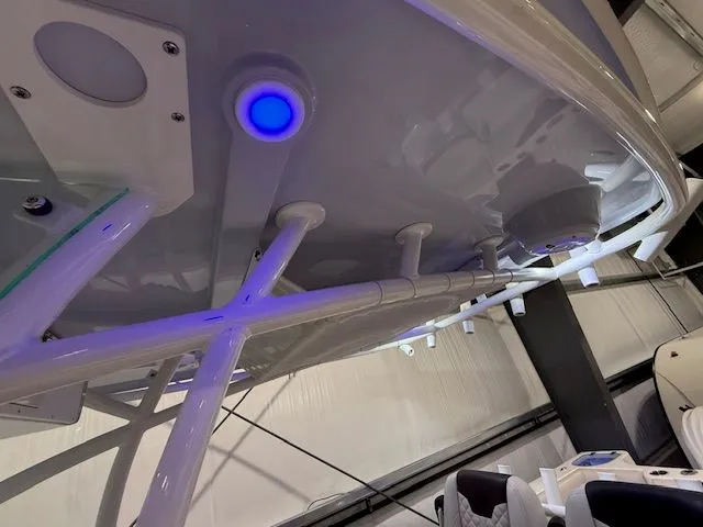 Slide: The Image of 2022 Sailfish 290cc boat interior with blue LED lighting and modern design features. - 17