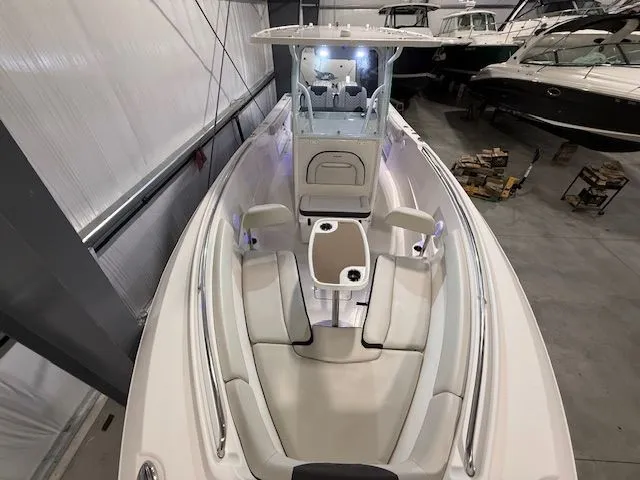 Slide: The Image of 2022 Sailfish 290cc boat interior with seating, in a storage facility. - 9