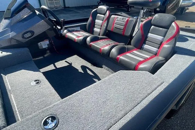 Slide: The Image of 2021 Ranger RT178 boat interior with gray and red seating, steering wheel, and carpeted flooring. - 4