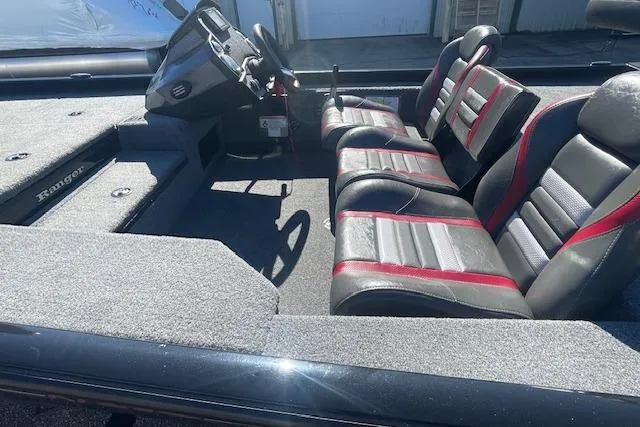 Slide: The Image of 2021 Ranger RT178 boat interior with black and red seats, steering console, and carpeted flooring. - 5