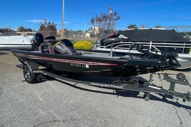 Slide: The Image of 2021 Ranger RT178 boat on trailer, parked outdoors under clear blue sky. - 9